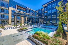 Colorado Springs apartment for rent - A modern building with a pool and lounge area.
