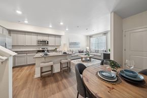 Aurora townhouse for rent - A modern kitchen with a dining table set for two.