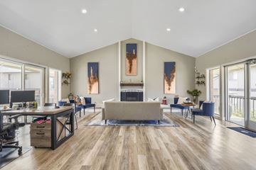 Denver apartment for rent - A spacious living room with a fireplace and a large painting on the wall.