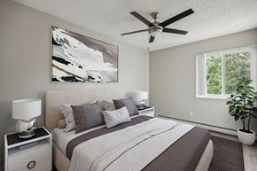 Colorado Springs apartment for rent - a bedroom with a large bed and a ceiling fan
