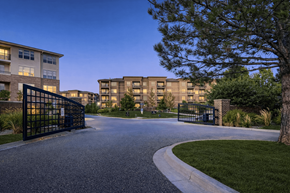 Englewood apartment for rent - A gated entrance to a residential complex with a tree on the right.