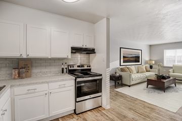 Denver apartment for rent - A modern kitchen with white cabinets and a stainless steel oven.