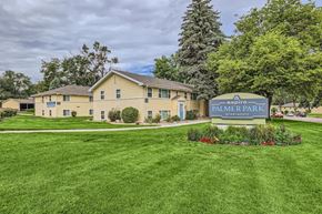 Colorado Springs apartment for rent - A sign for Palmer Park Apartments is in front of a building.