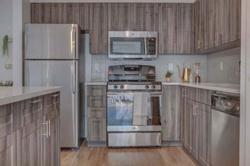 South Jordan apartment for rent - A modern kitchen with a stainless steel refrigerator and oven.