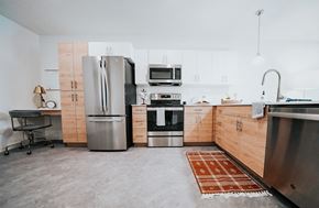 Salt Lake City apartment for rent - a kitchen with wooden cabinets and stainless steel appliances