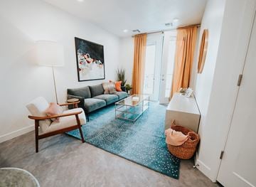 Salt Lake City apartment for rent - a living room with a blue rug and a couch