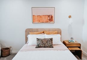 Salt Lake City apartment for rent - a bedroom with a bed with a pillow and a painting on the wall