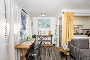 Englewood apartment for rent - A dining area with a table set for two and a couch.