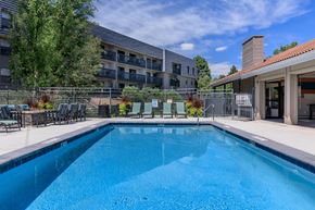 Denver apartment for rent - A swimming pool in a residential area with a building in the background.