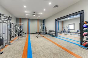 Denver apartment for rent - A gym with a variety of equipment including weights and cardio machines.