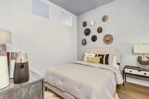 Indian Land apartment for rent - A bedroom with a bed, nightstand, and wall decor.