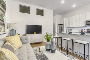 Indian Land apartment for rent - A modern living room with a grey couch and a grey coffee table.