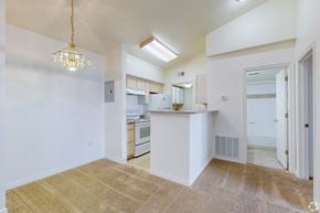 Englewood apartment for rent - A kitchen with white cabinets and a white fridge.