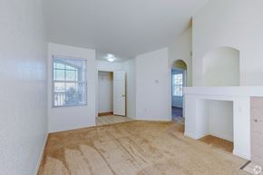 Englewood apartment for rent - A room with a carpeted floor and white walls.