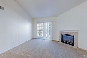 Englewood apartment for rent - A room with a fireplace and a window with blinds.