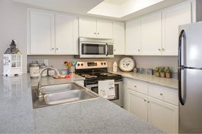 Colorado Springs apartment for rent - a kitchen with stainless steel appliances and white cabinets