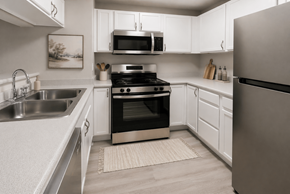 Albuquerque apartment for rent - A modern kitchen with a stainless steel refrigerator, oven, and microwave.
