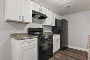 Phoenix apartment for rent - A kitchen with black appliances and white cabinets.