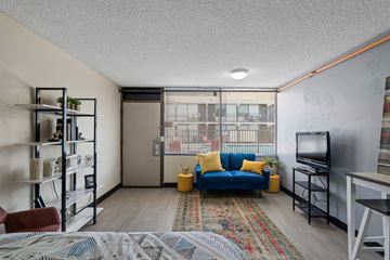 Mesa apartment for rent - A living room with a blue couch and a television.