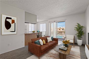 Yuma apartment for rent - A living room with a brown couch and a painting on the wall.
