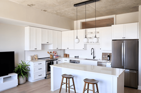 Denver apartment for rent - A modern kitchen with white cabinets and a large island.