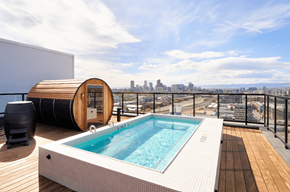 Denver apartment for rent - A hot tub on a wooden deck with a city skyline in the background.