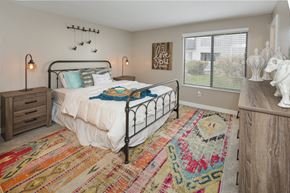 Colorado Springs apartment for rent - a bedroom with a bed and a dresser and a window