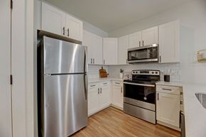 Colorado Springs apartment for rent - a kitchen with stainless steel appliances and white cabinets