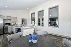 Jacksonville apartment for rent - A modern kitchen with a wooden table and chairs.