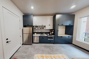 Salt Lake City apartment for rent - a kitchen with black and white cabinets and stainless steel appliances