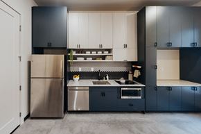 Salt Lake City apartment for rent - a kitchen with blue and white cabinets and stainless steel appliances