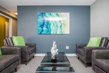 Thornton apartment for rent - A living room with a large painting on the wall and a sculpture on the coffee table.