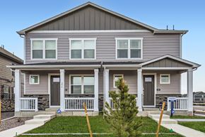 Aurora apartment for rent - A grey house with a front porch and a small tree in front.