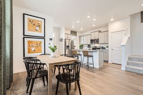 Aurora apartment for rent - A modern kitchen with a dining table and chairs.