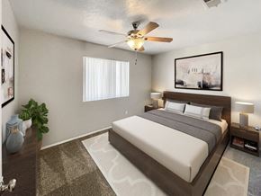 Albuquerque apartment for rent - A bedroom with a large bed and a ceiling fan.