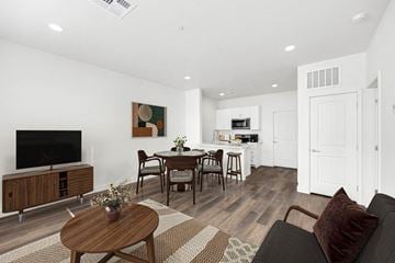 Youngtown apartment for rent - A modern living room with a wooden coffee table and a flat screen TV.