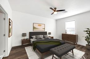Youngtown apartment for rent - A bedroom with a bed, nightstand, and a plant.