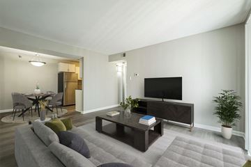 Little Rock apartment for rent - A living room with a grey couch and a television.