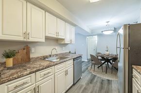 Little Rock apartment for rent - A kitchen with a table and chairs in the middle of the room.