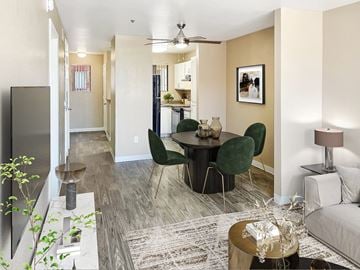 Casa Grande apartment for rent - A living room with a grey couch, a round table with green chairs, and a rug on the floor.