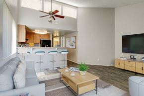 Casa Grande apartment for rent - A living room with a grey couch, a wooden coffee table, and a ceiling fan.