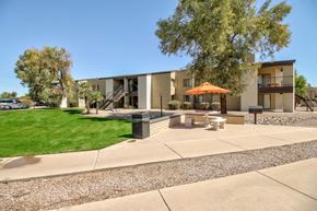 Casa Grande apartment for rent - A modern building with a patio and a tree in front.