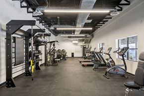 Tucson apartment for rent - A gym with a variety of exercise equipment including treadmills, weights, and exercise bikes.