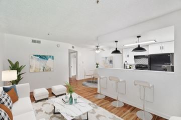 Tucson apartment for rent - A modern living room with a white couch and a coffee table.