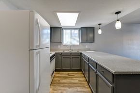 Las Vegas apartment for rent - A kitchen with a white refrigerator and wooden floors.
