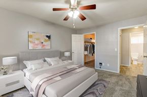 Las Vegas apartment for rent - A bedroom with a large bed and a ceiling fan.