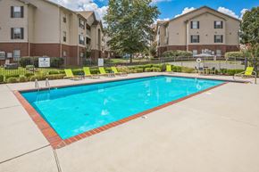 Sherwood apartment for rent - A swimming pool in a residential area with apartment buildings in the background.