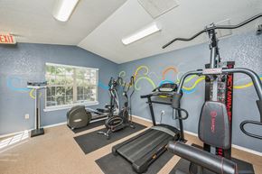 Sherwood apartment for rent - A gym with exercise equipment and a window.