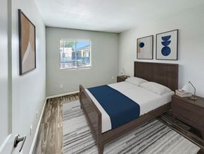 Phoenix apartment for rent - A bedroom with a bed, nightstand, and two framed pictures on the wall.