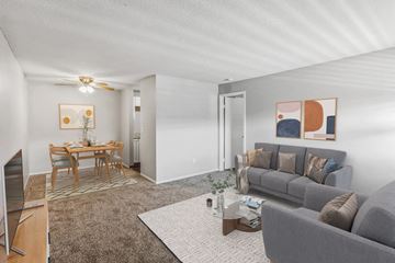 Olathe apartment for rent - A living room with a grey couch and a coffee table.